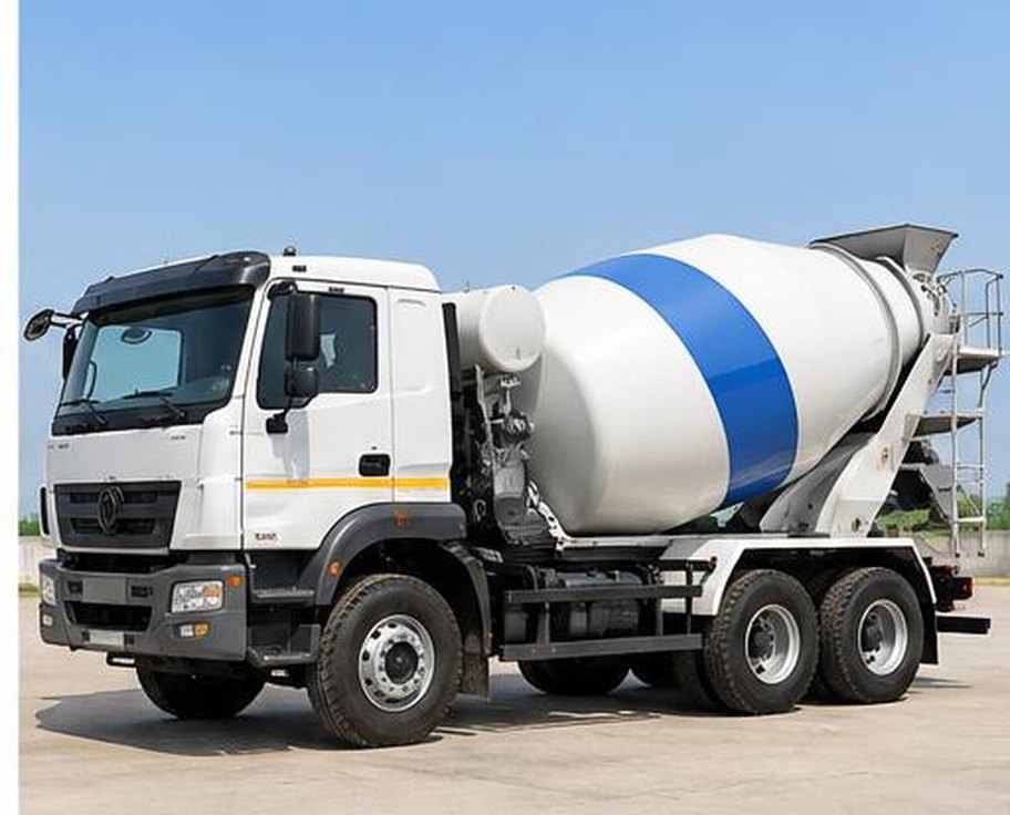 White and blue concrete transit mixer truck in a batching yard